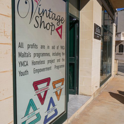 This is an image of outside the YMCA Charity & Vintage Shop. It shows the facade of the shop and front signage.