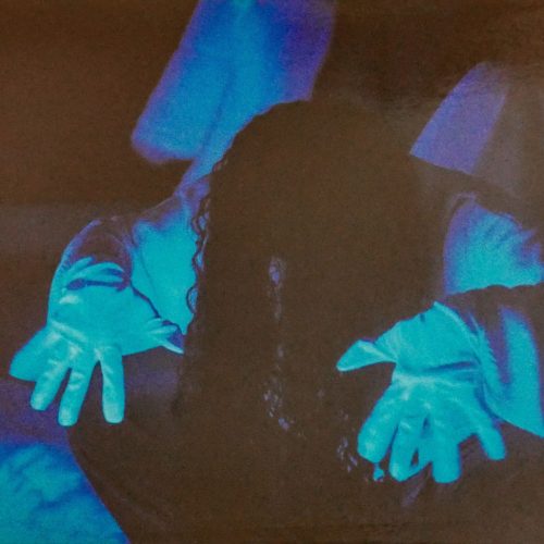 Performance artists under UV lights during Tensing.